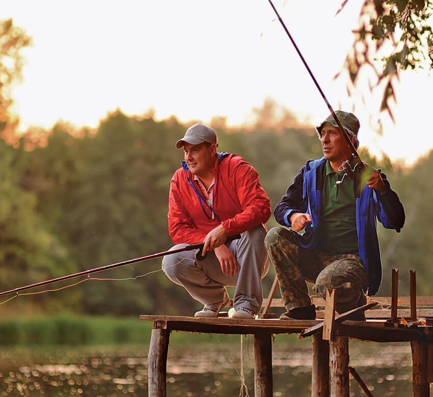 Two fishermen on a lake's dock