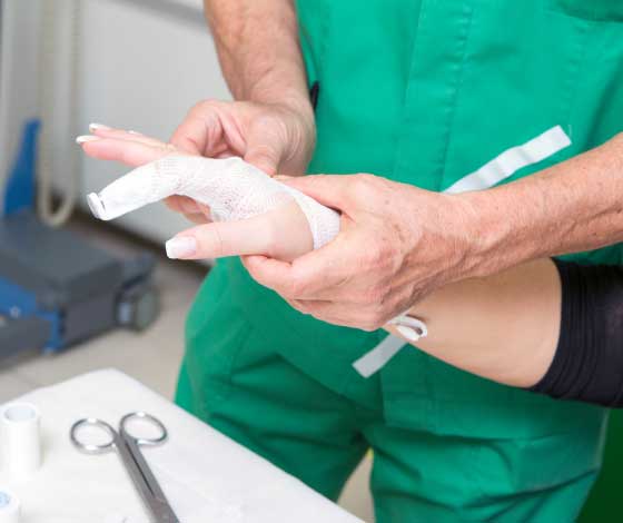 Doctor examining patient with a broken finger