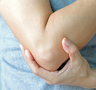 Hand cradling elbow in pain