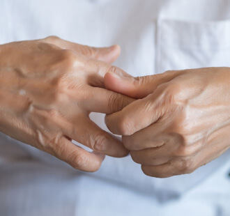 Woman rubbing her sore hands together